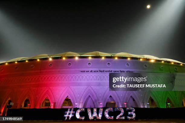 The Ekana Cricket Stadium is illuminated with India's national flag colours, on the eve of the 2023 ICC Men's Cricket World Cup one-day international...