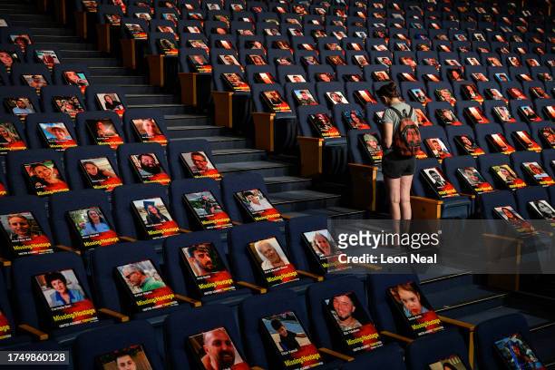 Pictures of over 1,000 persons abducted, missing or killed in the Hamas attack are displayed on empty seats in the Smolarz Auditorium at Tel Aviv...