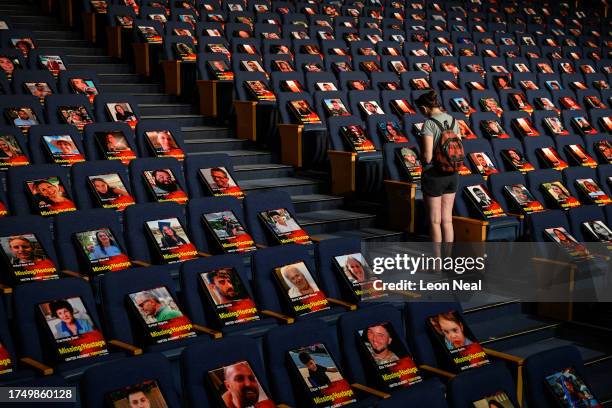 Pictures of over 1,000 persons abducted, missing or killed in the Hamas attack are displayed on empty seats in the Smolarz Auditorium at Tel Aviv...