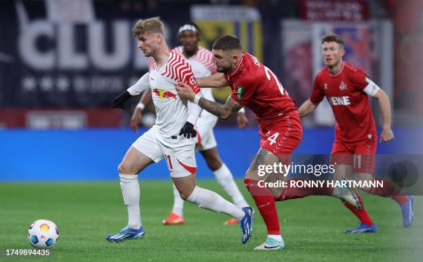 Leipzig's German forward Timo Werner and Cologne's German defender Jeff Chabot vie for the ball during the German first division Bundesliga football...