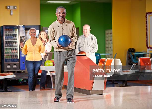 senior man bowling - man holding bowling ball stock pictures, royalty-free photos & images