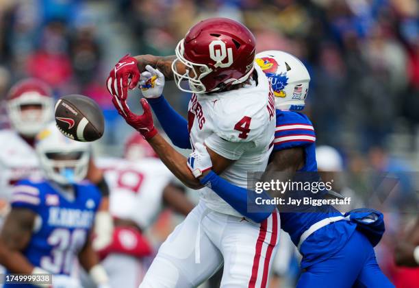 Wide receiver Nic Anderson of the Oklahoma Sooners is unable to make the catch against cornerback Cobee Bryant of the Kansas Jayhawks during the...