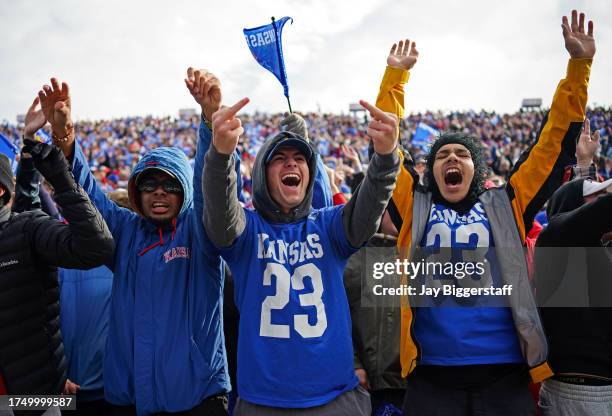 Fans of the Kansas Jayhawks cheer after a touchdown during the first half against the Oklahoma Sooners at David Booth Kansas Memorial Stadium on...