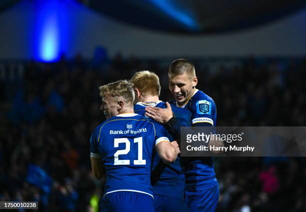 Dublin , Ireland - 28 October 2023; Tommy O'Brien of Leinster, centre, celebrates with teammates Ben Murphy and Sam Prendergast after scoring his...