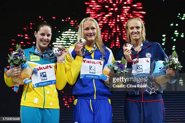 Silver medal winner Alicia Coutts of Australia, Gold medal winner Sarah Sjostrom of Sweden and bronze medal winner Dana Vollmer of the USA celebrate...