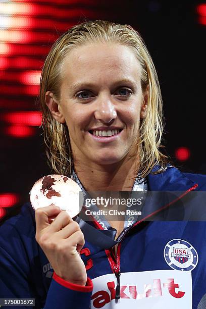 Bronze medal winner Dana Vollmer of the USA celebrates on the podium after the Swimming Women's 100m Butterfly Final on day ten of the 15th FINA...