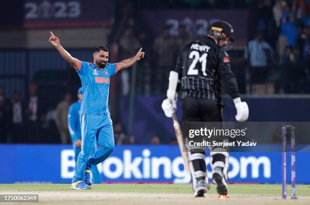 Mohammed Shami of India celebrates the wicket of Matt Henry of New Zealand during the ICC Men's Cricket World Cup India 2023 match between India and...