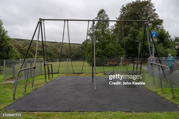 Swings in an empty children's play park on an overcast wet day on September 17, 2023 in Truro, England.