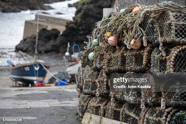 Lobster a crab pots are stacked at the fishing village, small harbour on September 17, 2023 in Portloe, England.