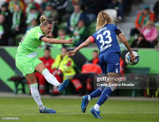 Alexandra Popp of VfL Wolfsburg is challenged by Fabienne Dongus of TSG 1899 Hoffenheim during the Google Pixel Frauen-Bundesliga match between VfL...