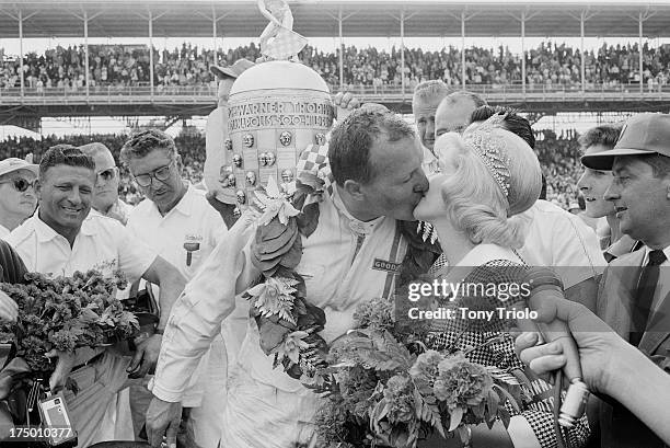 Indianapolis 500: A.J. Foyt victorious in Victory Lane, kissing 500 Festival queen Donna McKinley Frazier after winning race at Indianapolis Motor...