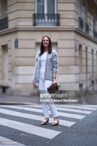 Alba Garavito Torre wears a white t-shirt from Zara, a grey fluffy cashmere cardigan with chain-detailed pockets from Crush Collection, white...