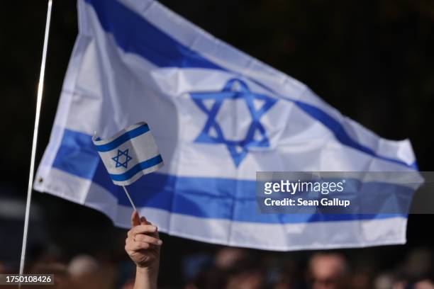 People gather under Israeli flags at a demonstration to show solidarity with Israel and against anti-semitism on October 22, 2023 in Berlin, Germany....