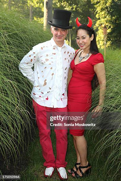 Kevin Berlin and Anhthu Nguyen attend The 20th Annual Watermill Center Summer Benefit at The Watermill Center on July 27, 2013 in Water Mill, New...