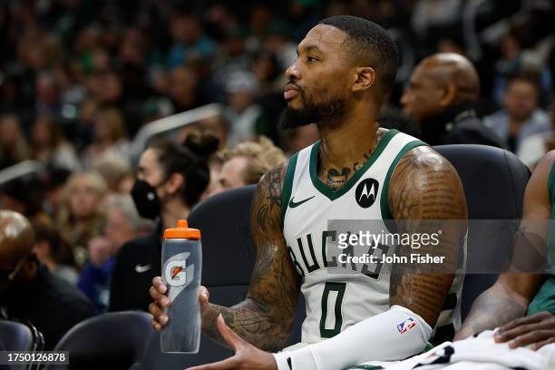 Damian Lillard of the Milwaukee Bucks drinks Gatorade during the preseason game against the Memphis Grizzlies at Fiserv Forum on October 20, 2023 in...