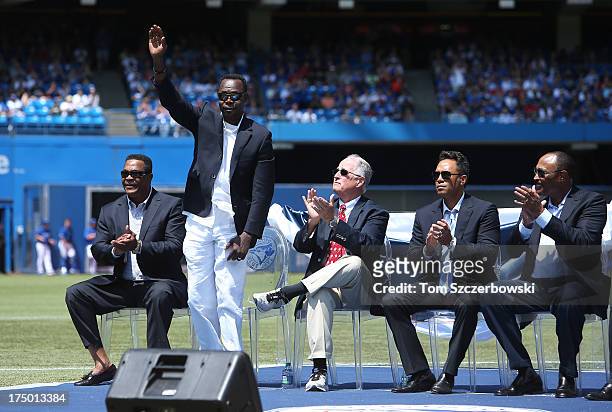 Former player Tony Fernandez acknowledges the crowd as he is introduced during a pre-game ceremony for former player Carlos Delgado of the Toronto...