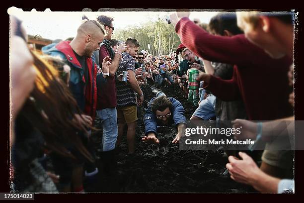 Festival-goer runs and dives into mud on day 3 of the 2013 Splendour In The Grass Festival on July 28, 2013 in Byron Bay, Australia.