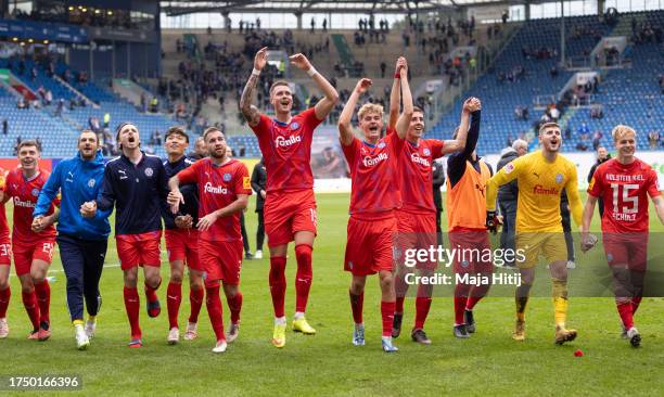 Players of Holstein Kiel celebrate with fans after winning the Second Bundesliga match between F.C. Hansa Rostock and Holstein Kiel at Ostseestadion...