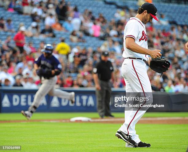 Brandon Beachy of the Atlanta Braves reacts after giving up a second inning home run against Wilin Rosario of the Colorado Rockies at Turner Field on...