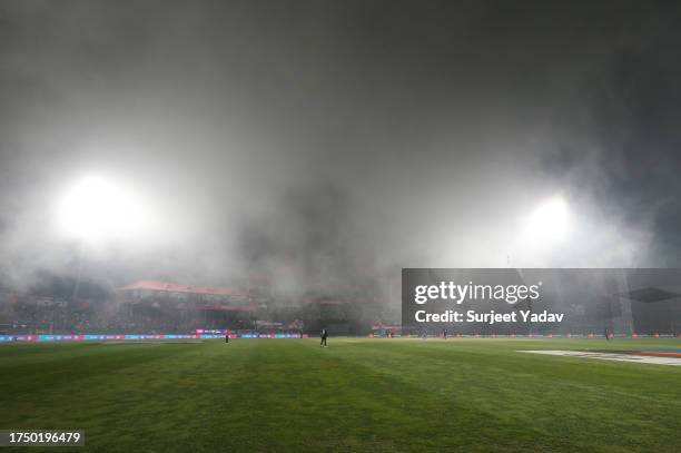 Mist and fog is seen and pauses playduring the ICC Men's Cricket World Cup India 2023 match between India and New Zealand at HPCA Stadium on October...