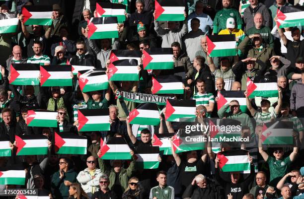 Celtic supporters show their support with Palestine flags during the Cinch Scottish Premiership match between Heart of Midlothian and Celtic FC at...