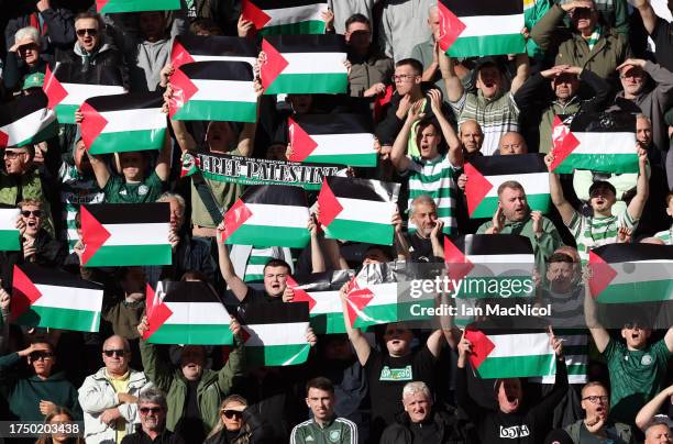 Celtic supporters show their support with Palestine flags during the Cinch Scottish Premiership match between Heart of Midlothian and Celtic FC at...