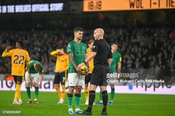 Referee Anthony Taylor and Bruno Guimarães of Newcastle United after Newcastle awared a penalty that Callum Wilson of Newcastle United would later...