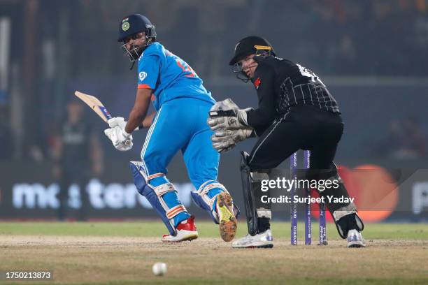 Shreyas Iyer of India bats as wicket keeper, Tom Latham of New Zealand looks on during the ICC Men's Cricket World Cup India 2023 match between India...