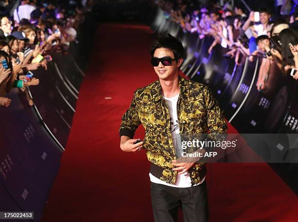 This photo taken on July 29, 2013 shows South Korean actor Kim Ji-hoon arriving on the red carpet to attend the premiere of the film "Snowpiercer" in...