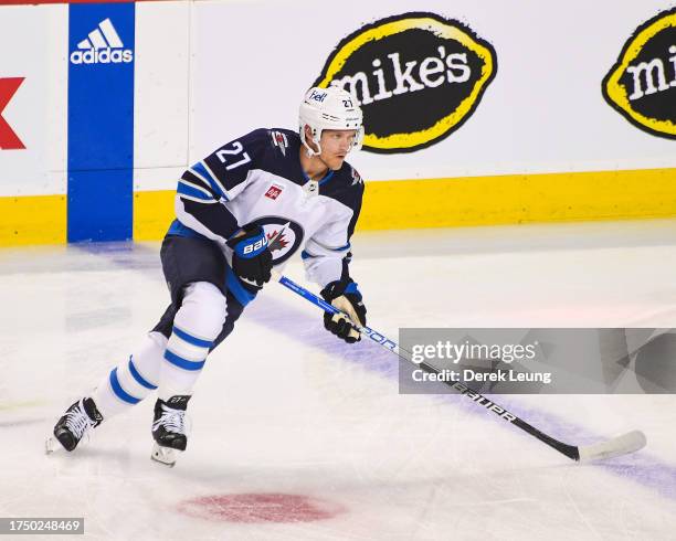 Nikolaj Ehlers of the Winnipeg Jets in action against the Calgary Flames during an NHL game at Scotiabank Saddledome on October 11, 2023 in Calgary,...