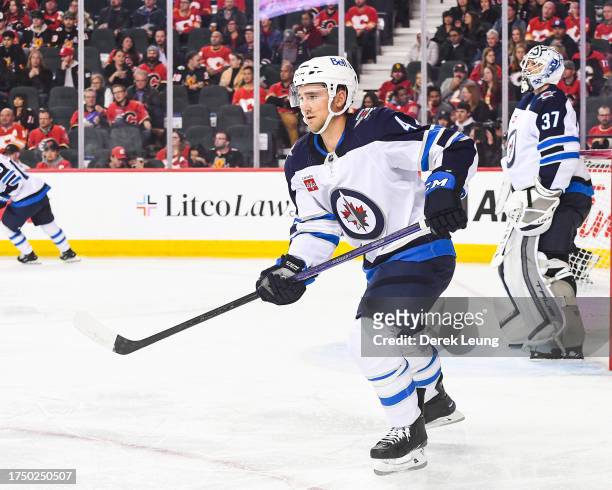 Neal Pionk of the Winnipeg Jets in action against the Calgary Flames during an NHL game at Scotiabank Saddledome on October 11, 2023 in Calgary,...
