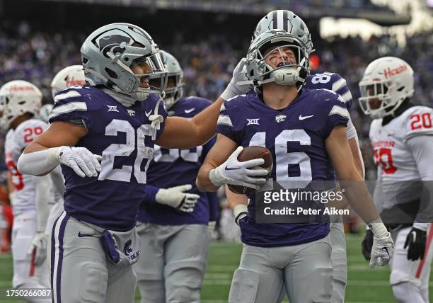 Seth Porter of the Kansas State Wildcats celebrates with Anthony Frias II after scoring a touchdown in the second half against the Houston Cougars at...
