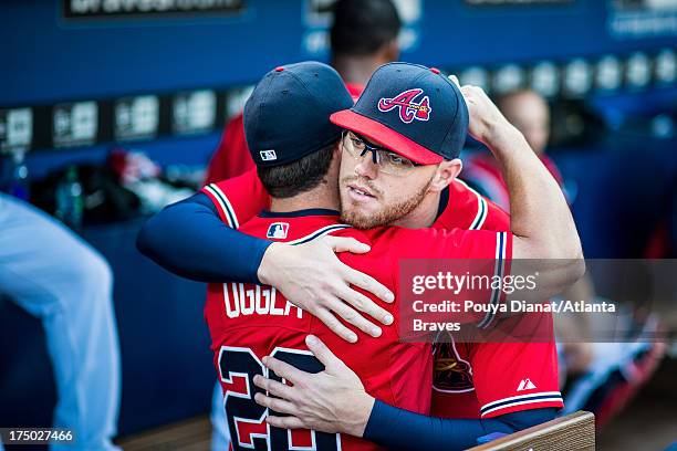 Dan Uggla and Freddie Freeman of the Atlanta Braves hug before the game against the Chicago Cubs at Turner Field on April 5, 2013 in Atlanta,...