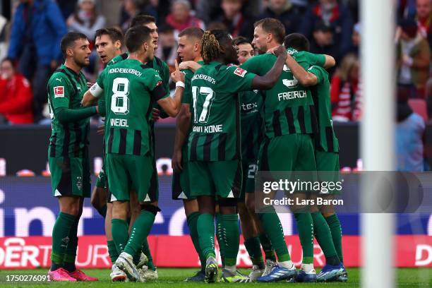 Nico Elvedi of Borussia Moenchengladbach celebrates with teammates after scoring the team's first goal to equalise during the Bundesliga match...