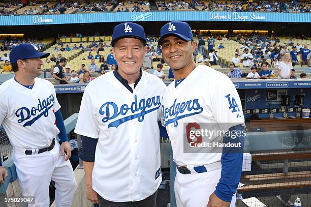 In this handout photo provided by the Los Angeles Dodgers, Bryan Cranston and Jerry Hairston, Jr. Attend the Cincinnatti Reds versus Los Angeles...