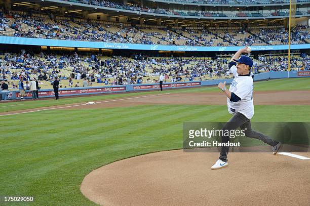 In this handout photo provided by the Los Angeles Dodgers, Bryan Cranston throws the first pitch at the Cincinnatti Reds versus Los Angeles Dodgers...