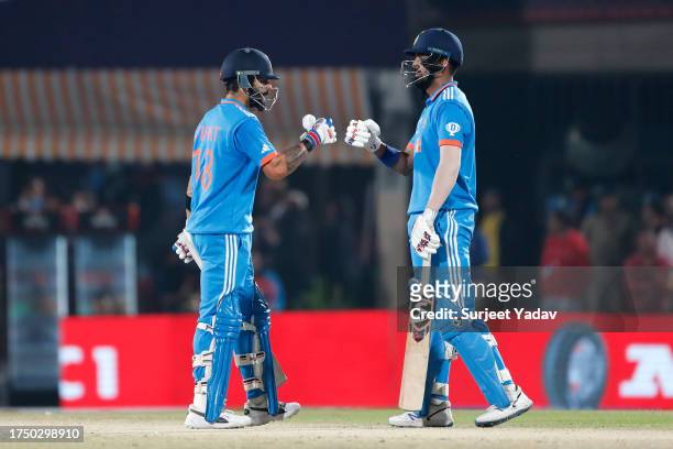 Virat Kohli and KL Rahul of India interact during the ICC Men's Cricket World Cup India 2023 match between India and New Zealand at HPCA Stadium on...