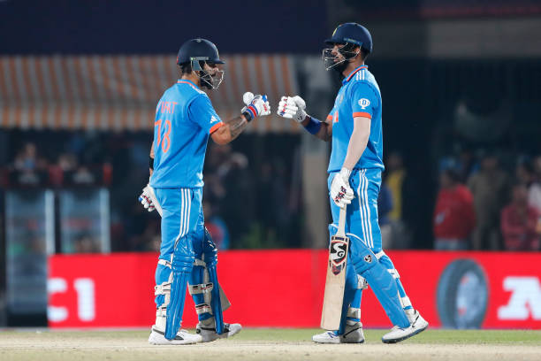Virat Kohli and KL Rahul of India interact during the ICC Men's Cricket World Cup India 2023 match between India and New Zealand at HPCA Stadium on...