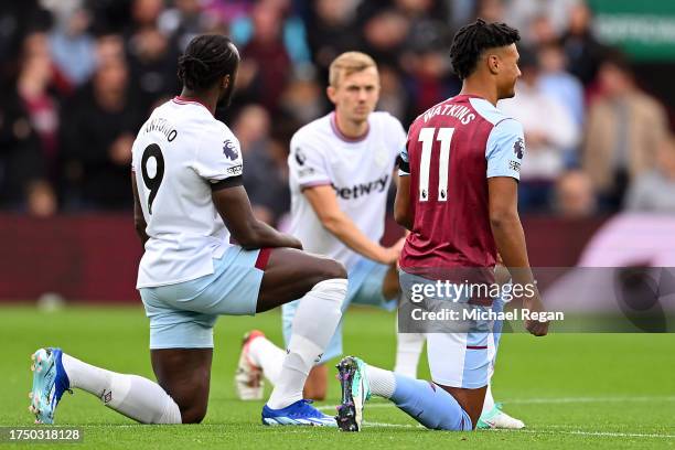 Michail Antonio of West Ham United and Ollie Watkins of Aston Villa take a knee in support of the No Room for Racism campaign prior to the Premier...