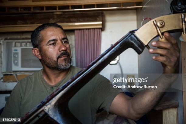 Samuel Garcia plays music with his brother in their trailer on July 29, 2013 in Watford City, North Dakota. The Garcia brothers live in the trailer...