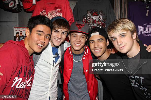 Will Jay, Cole Pendery, Dana Vaughns, Gabe Morales and Dalton Rapattoni of the group IM5 visit Planet Hollywood Times Square on July 29, 2013 in New...