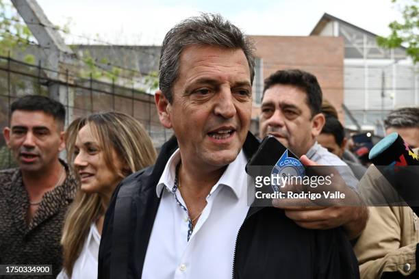 Presidential candidate for Union Por La Patria Sergio Massa arrives along Malena Galmarini President of AYSA at the polling station as he talks to...
