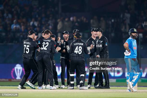 New Zealand players celebrate the wicket of KL Rahul of India during the ICC Men's Cricket World Cup India 2023 match between India and New Zealand...