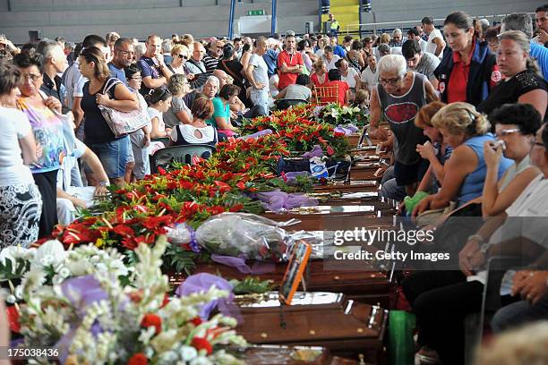 Relatives gather to grieve near to the coffins of the victims of the Monteforte Irpino coach crash during the funeral held at a local indoor sports...