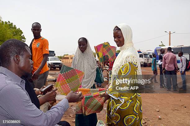 Woman sells fans in a street of Gao on July 29 a day after the presidential vote. An ancient capital of West Africa's Songhai empire, the Malian city...