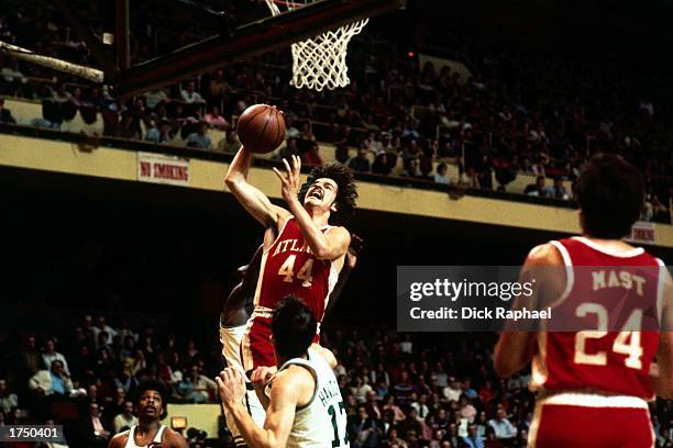 Pete Maravich of the Atlanta Hawks drives to the basket for a layup against the Boston Celtics during the NBA game at the Boston Garden during the...