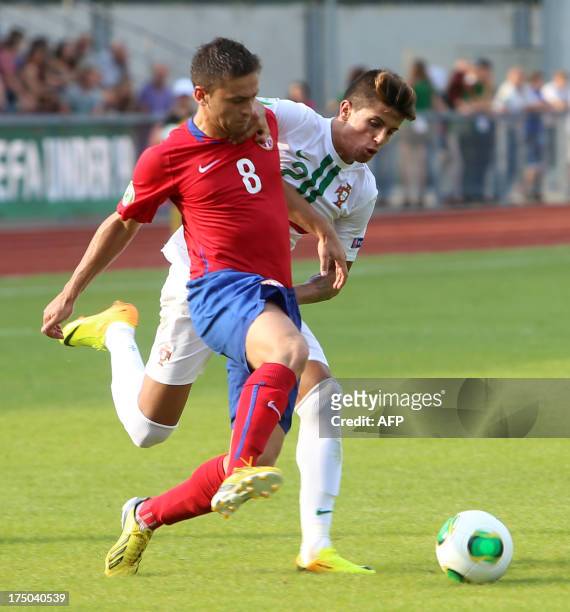 Dejan Meleg of Serbia and Joao Cancelo of Portugal vie for the ball during the UEFA European Under-19 Championship semi-final football match Serbia...