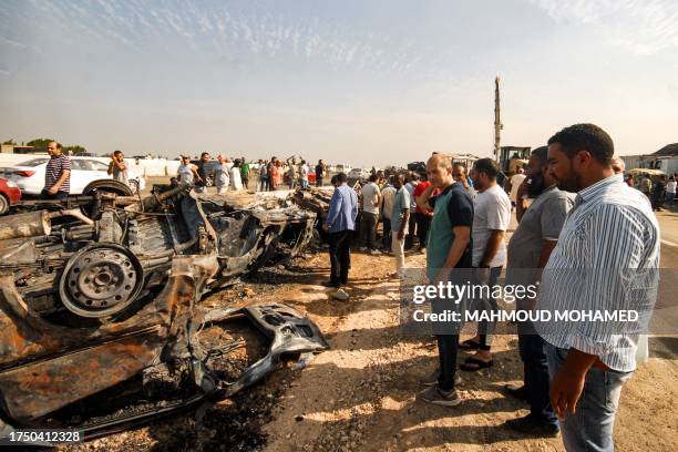 People view the wreckages of burnt vehicles at the site of a large traffic collision along the Cairo-Alexandria desert road near Wadi al-Natrun on...