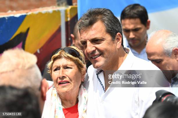 Presidential candidate for Union Por La Patria Sergio Massa poses with a supporter after casting his vote during the general elections at Escuela N34...