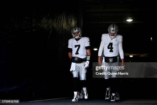 Brian Hoyer and Aidan O'Connell of the Las Vegas Raiders walk onto the field before the game against the Chicago Bears at Soldier Field on October...